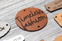 Round apple leather label with 'Timeless fashion' engraving - Item no. 3003
