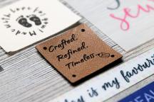 Brown faux leather label with laser-engraved 'Crafted. Refined. Timeless.' text - Item no. 3007