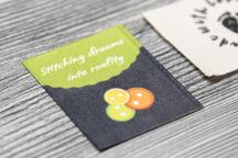 Satinera label with button motif and 'Stitching dreams into reality' text - Item no. 3007