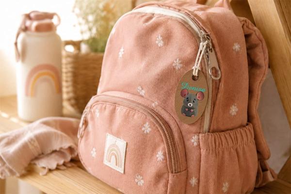 Sustainable cactus-based faux leather tag with a colored mouse motif and the name "Denisa" on backpack.