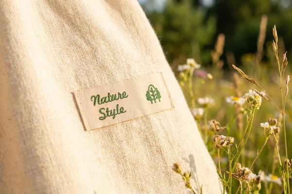 Natural cotton label with green lettering on a fabric bag